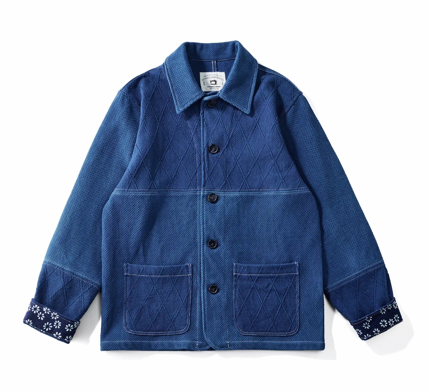 Blue denim jacket with floral cuffs on a white background