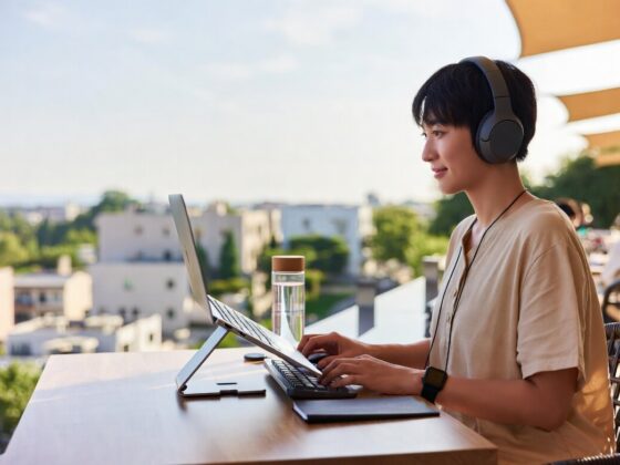 Japanese woman working with laptop outdoors